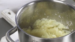 Blanched savoy cabbage being added to mashed potatoes