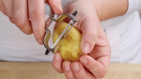A potato being peeled (close-up)