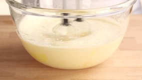 Eggs and sugar being mixed with an electric whisk