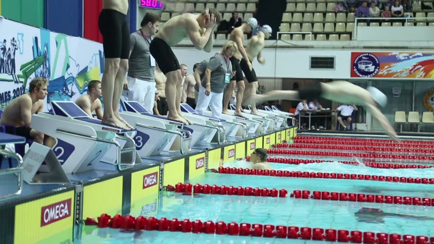 MOSCOW - APR 20: Swimmers jump into water during relay race in swimming pool at Championship of Russia in Olympic Sports complex on April 20, 2012 in Moscow, Russia