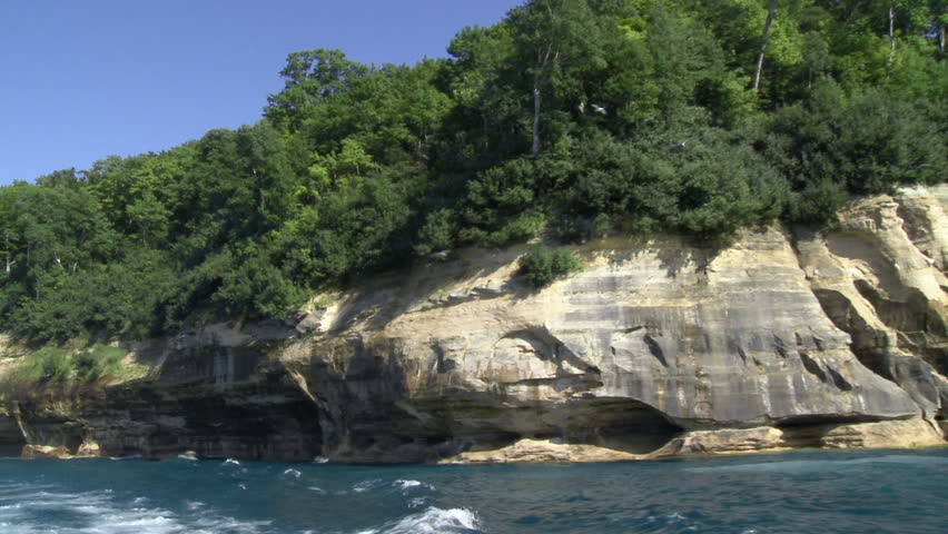 Seagulls flying around the cliffs at Pictured Rocks National Lakeshore park,