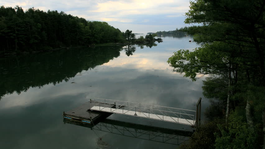 A beautiful, serene scene in Maine as clouds pass under a floating dock after a