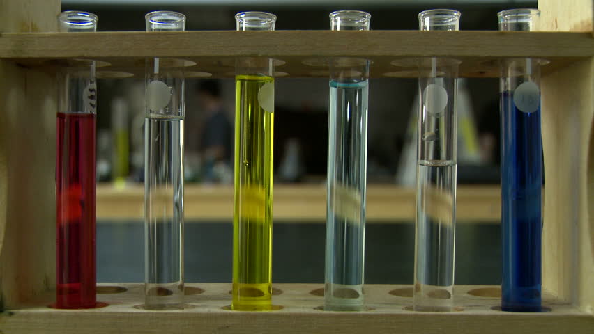 Six test tubes of colored liquid in sharp focus with soft focus laboratory