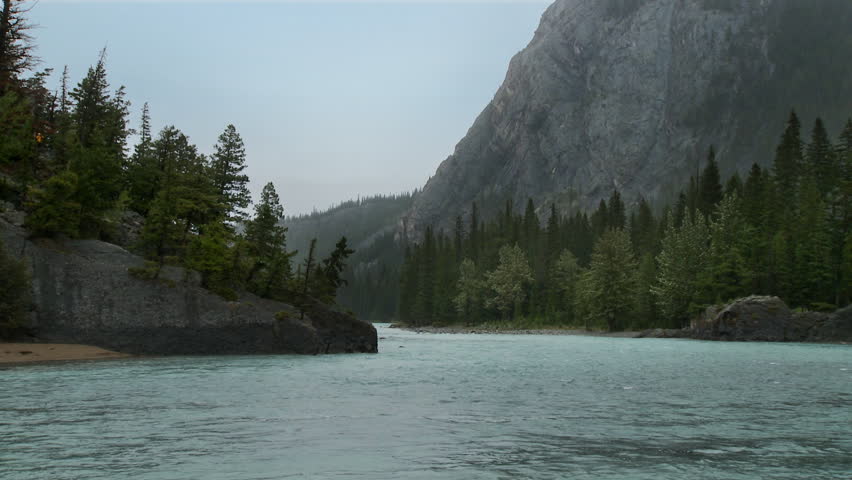 Rain falling steadily on the river in Banff, Alberta province, Canada.