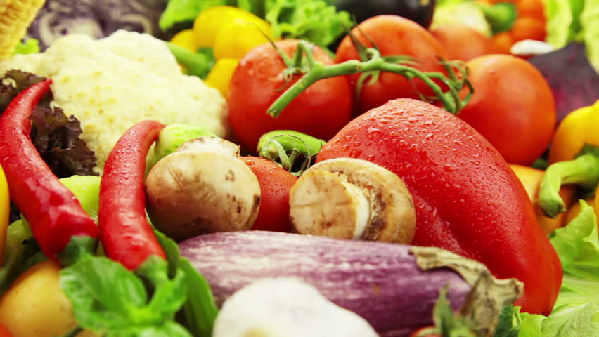 Fresh vegetables rotate: cabbage, carrot, corn, cucumber, garlic, onion, pepper,