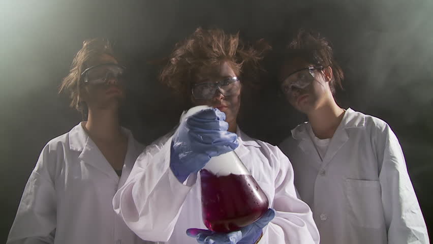 Three high school students regard the results of an experiment that seems to