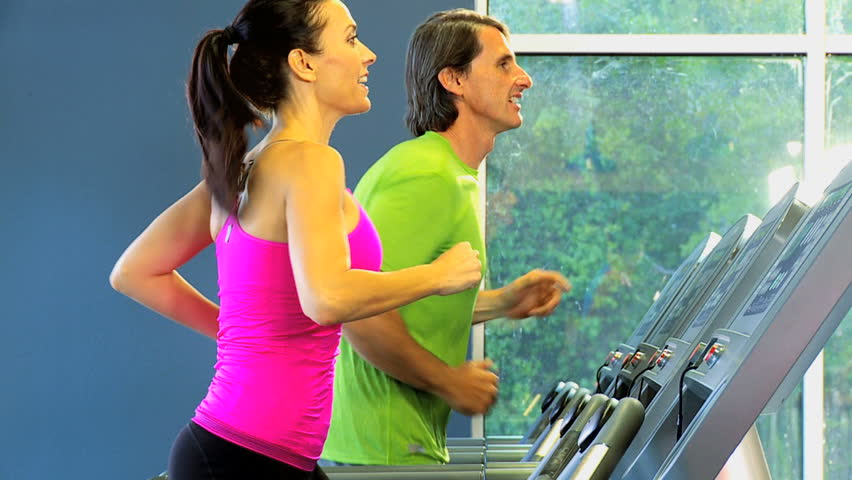 Male female Caucasian gym members keeping fit exercising on modern electrical modern equipment Royalty-Free Stock Footage #4267868