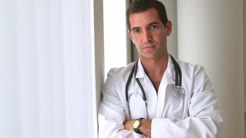 Male doctor standing by window | Shutterstock HD Video #4272899