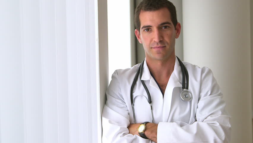 Confident male doctor standing by window | Shutterstock HD Video #4272956