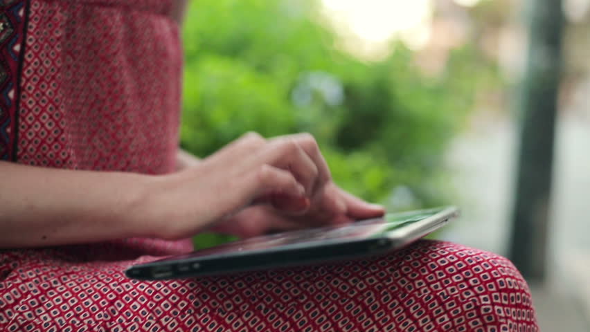 Woman hands with tablet computer outdoors, steadicam shot
