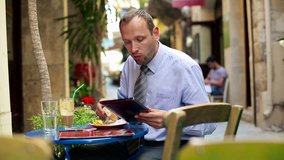 Young businessman with tablet computer during lunch in cafe
 - Powered by Shutterstock - Get 15% off with code: PIKWIZARD15