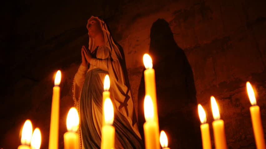 Holy statue of Mary with candles