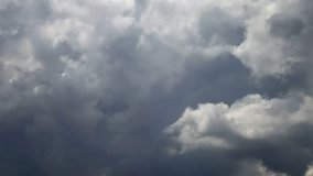 Time lapse clip of grey storm rain fluffy clouds over sky