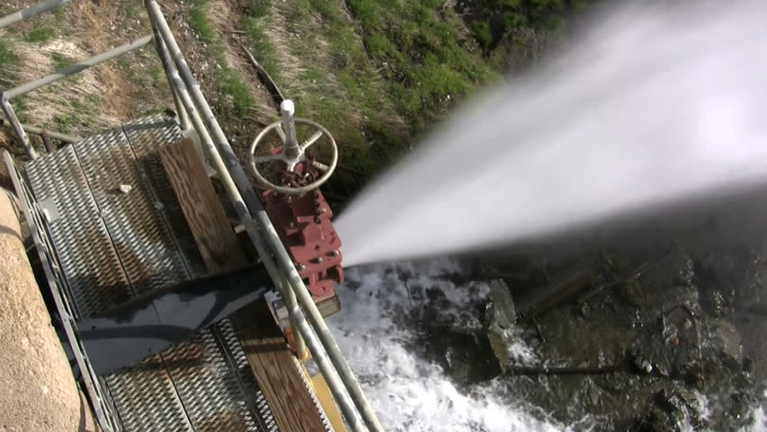 water shoots out at high pressure from the bottom of a dam