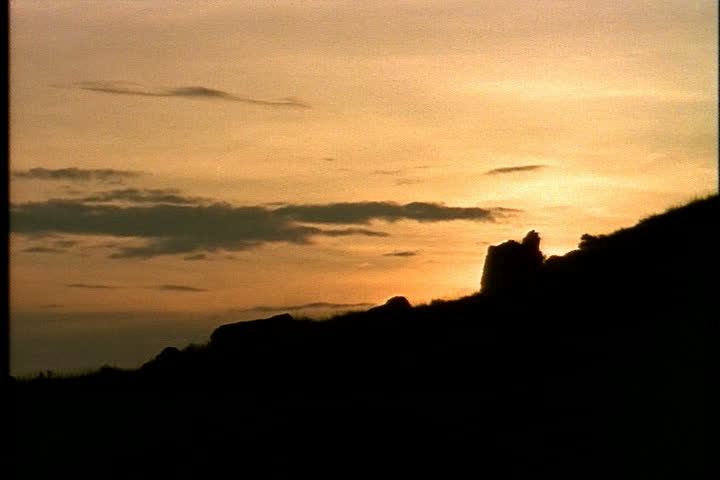 Streaky orange sunset over silhouette of landscape in Medora, North Dakota.