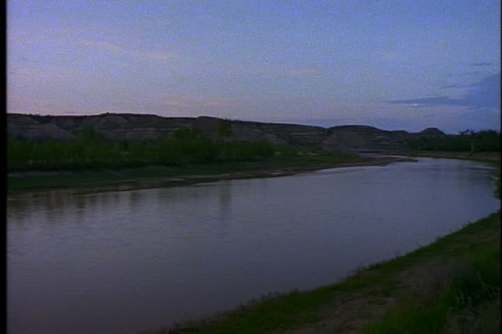 Pan of the calm Little Missouri River and surrounding hills in Medora, North Dakota.