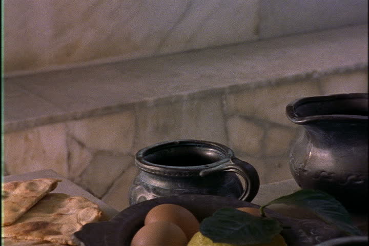 Re-creation of what a Pompeii meal might have looked like, food on table, woman