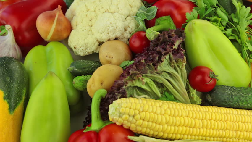 Fresh vegetables rotate: cabbage, carrot, corn, cucumber, garlic, onion, pepper,