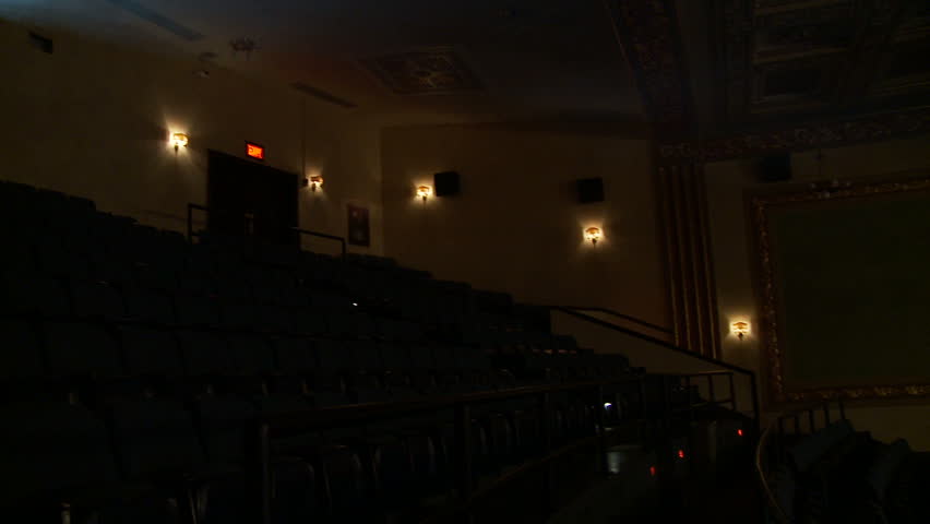 View of the light beam of a 35mm projector running in a semi-darkened movie