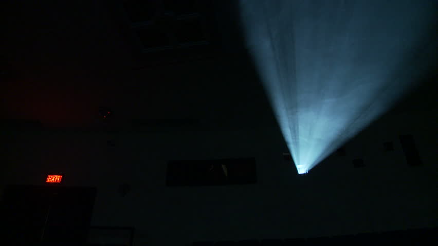 Low, front on view of the light beam from a 35mm projector running in a darkened