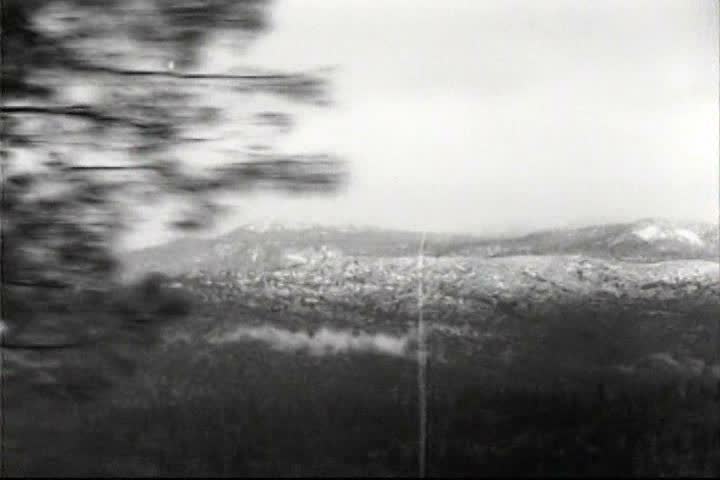 1930s - Cars fill up at a gas station in 1938 on their way to driving to Yosemite National park.