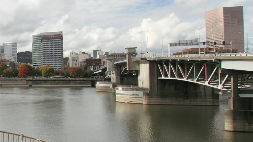 Portland Oregon Downtown City Skyline Waterfront View with Hawthorne and Morrison Bridges along Willamette River Traffic and Clouds Time Lapse in Fall Autumn Season 1080p