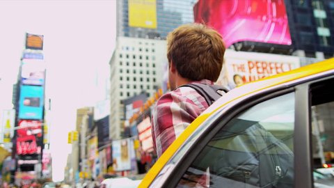 Male Caucasian wearing casual clothes backpack arriving yellow cab Times Square New York close up shot on RED EPIC