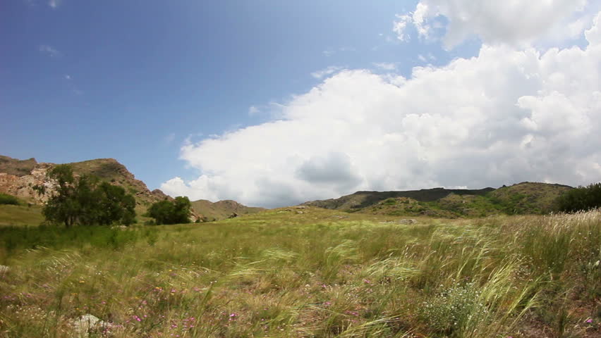 Timelapse clouds over a mountain range and nature reserve 