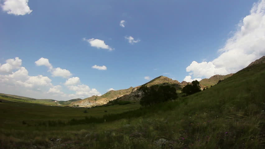 Timelapse clouds over a mountain range and nature reserve 