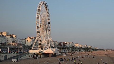 BRIGHTON, UNITED KINGDOM - JULY 12, 2013: People enjoying the evening sunshine on Brighton Beach on July 12.  Temperatures reached over 30 degrees Celsius over the weekend in Britain. 