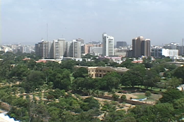 High angle shot of tree tops and Karachi skyline in Pakistan.
