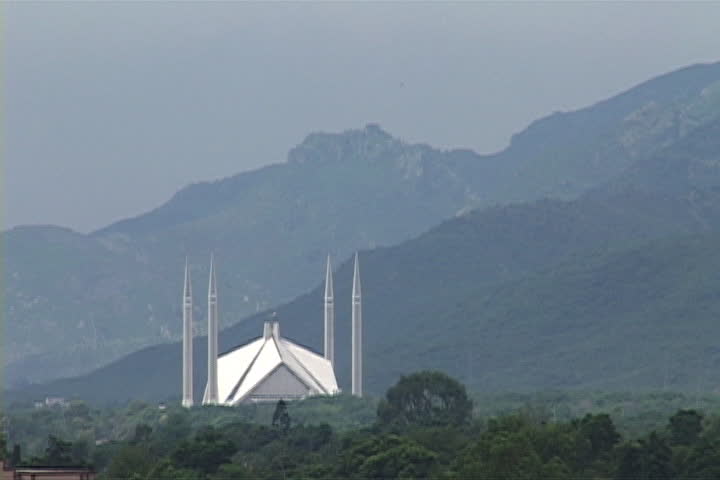 The modern Faisal Mosque, designed by Vedat Dalokay, surrounded by the misty Margalla Hills in Islamabad, Pakistan