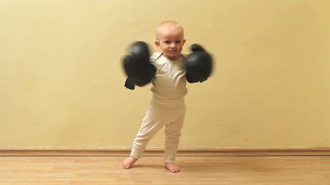 Funny little baby  threaten with his box gloves