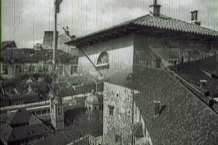 1940s - Captured Italian war film from 1941 shows Italian motorized columns, cavalry, artillery, and pack mules move through a Yugoslavian town and the Italian flag flies in victory.