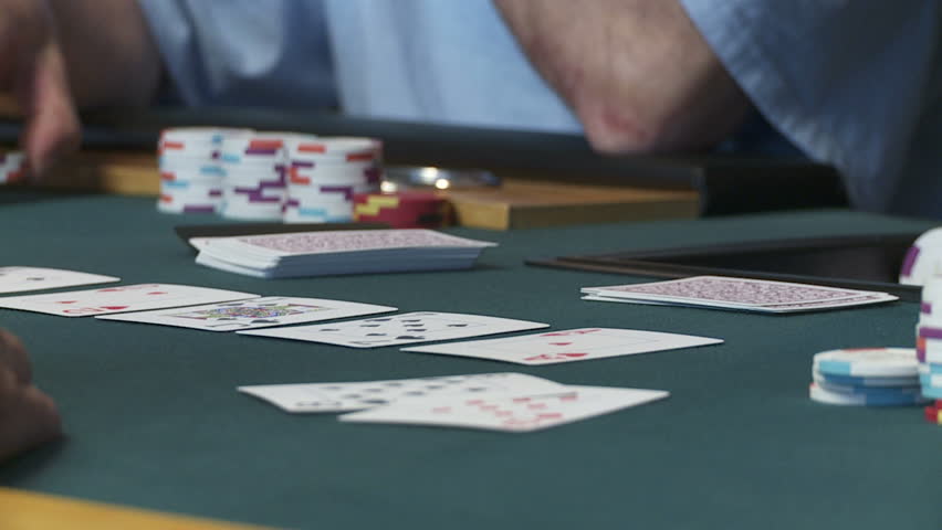 Close up on cards and chips during a poker game.  Slow motion, recorded at