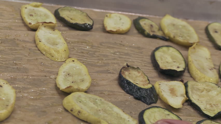Tight shot of roasted vegetables being served from an tray taken out of the