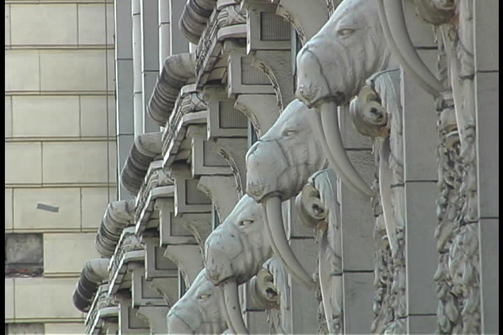 Row of walrus gargoyles with long tusks along the side of the Arctic Building in Seattle, Washington.