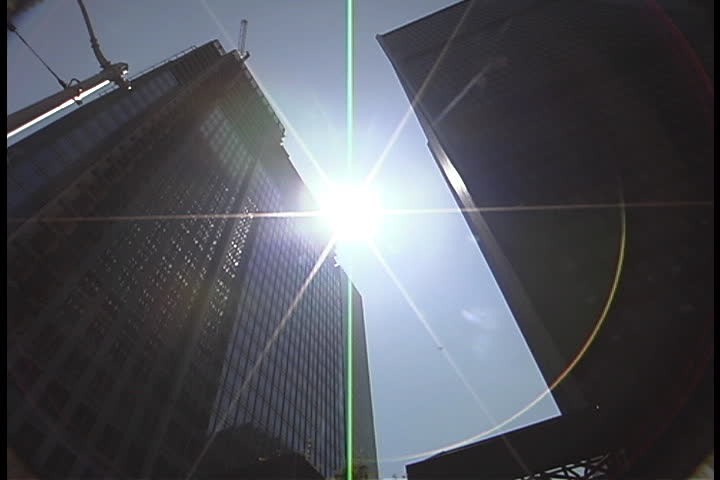 Sun shining down between skyscrapers in Seattle, Washington.