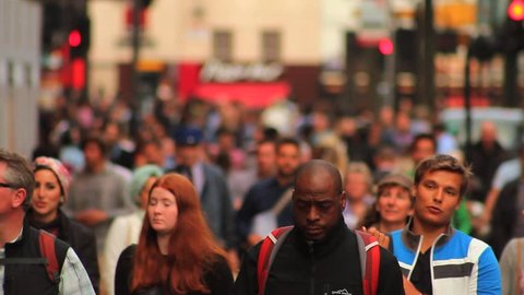 LONDON - July 3: Crowd of People / Commuters on Busy London Street on July 3 2013 in London England.