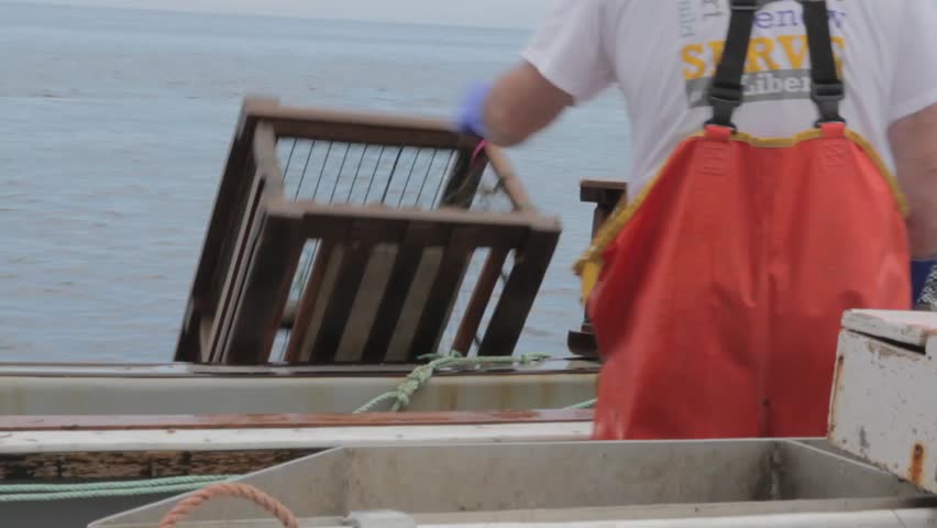 Commercial fishermen on the ocean fishing for lobster
