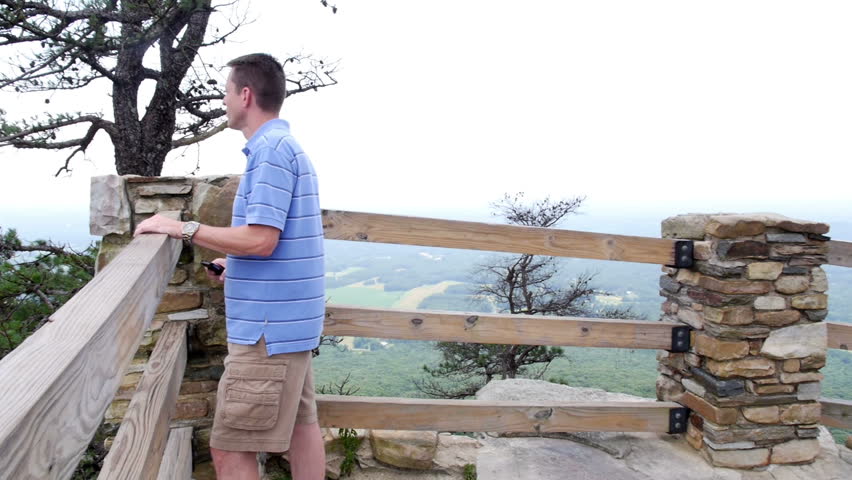 A visitor takes a picture of the top of Pilot Mountain.