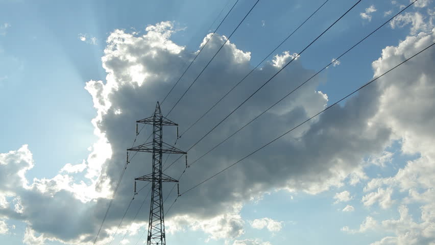 Pylon against blue sky with white clouds