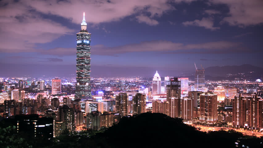 Taipei city at night with building lights on and off, car trails, time-lapse