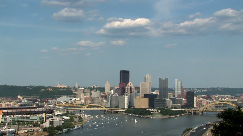 The Pittsburgh skyline on a sunny Spring day.  The large corporate logos on the