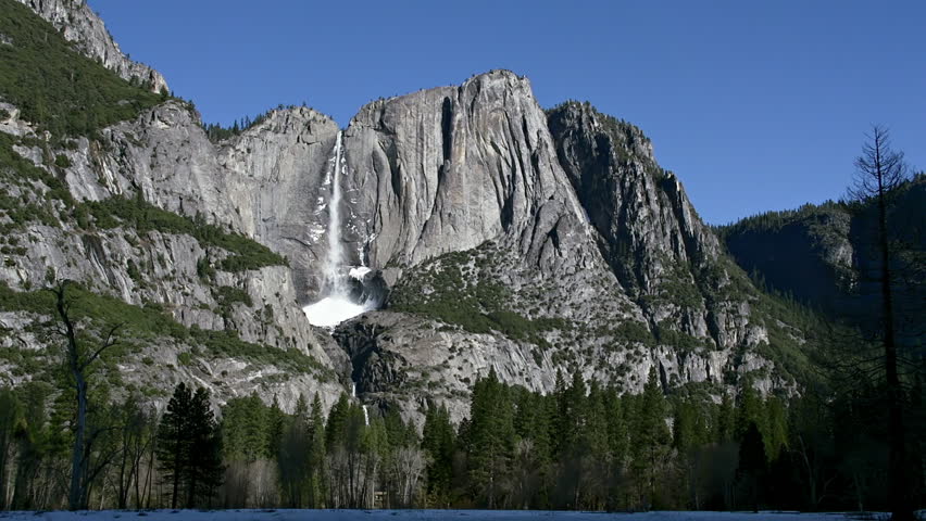 Medium shot of Yosemite Falls on a cloudless late morning with ice cone