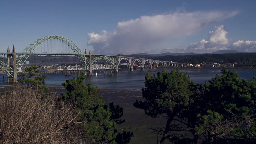 View of Yaquina Bay Bridge in Newport, Oregon, with sailboat