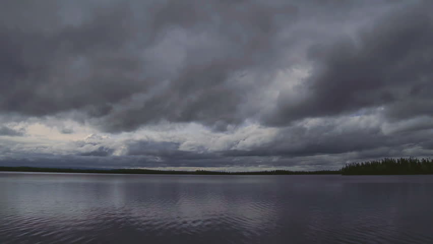 Time lapse of intense brooding storm clouds gather over Alaskan lake