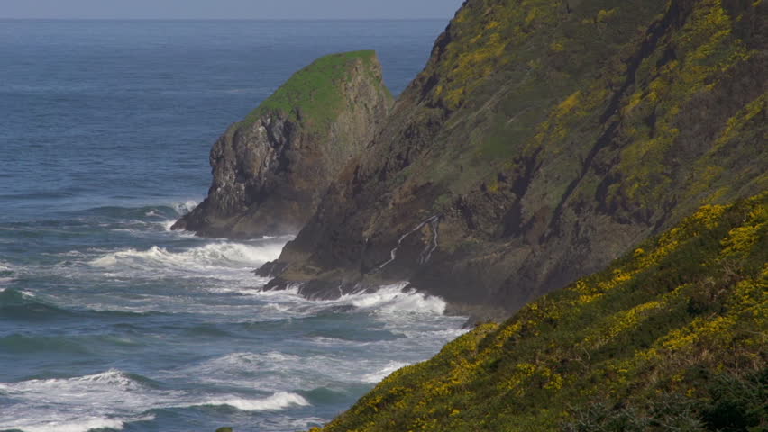 Closeup of waves washing against coastline cliffs of Oregon