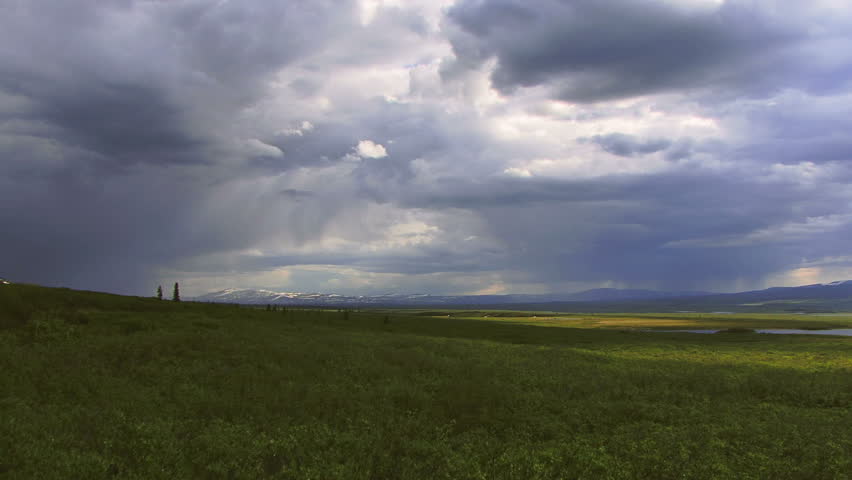 Breathtaking time lapse of Alaskan landscape with growing rain clouds 