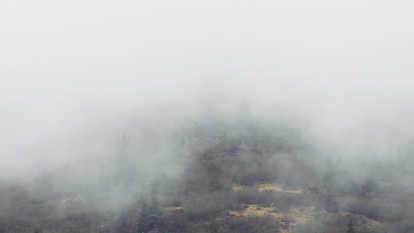 Time lapse of heavy mists on a rugged mountaintop in Alaska